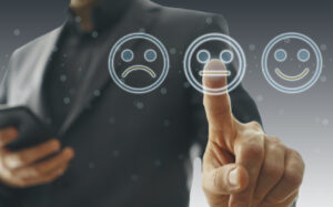 Businessman pointing at a neutral face icon, showing a concept of turning negative reviews.